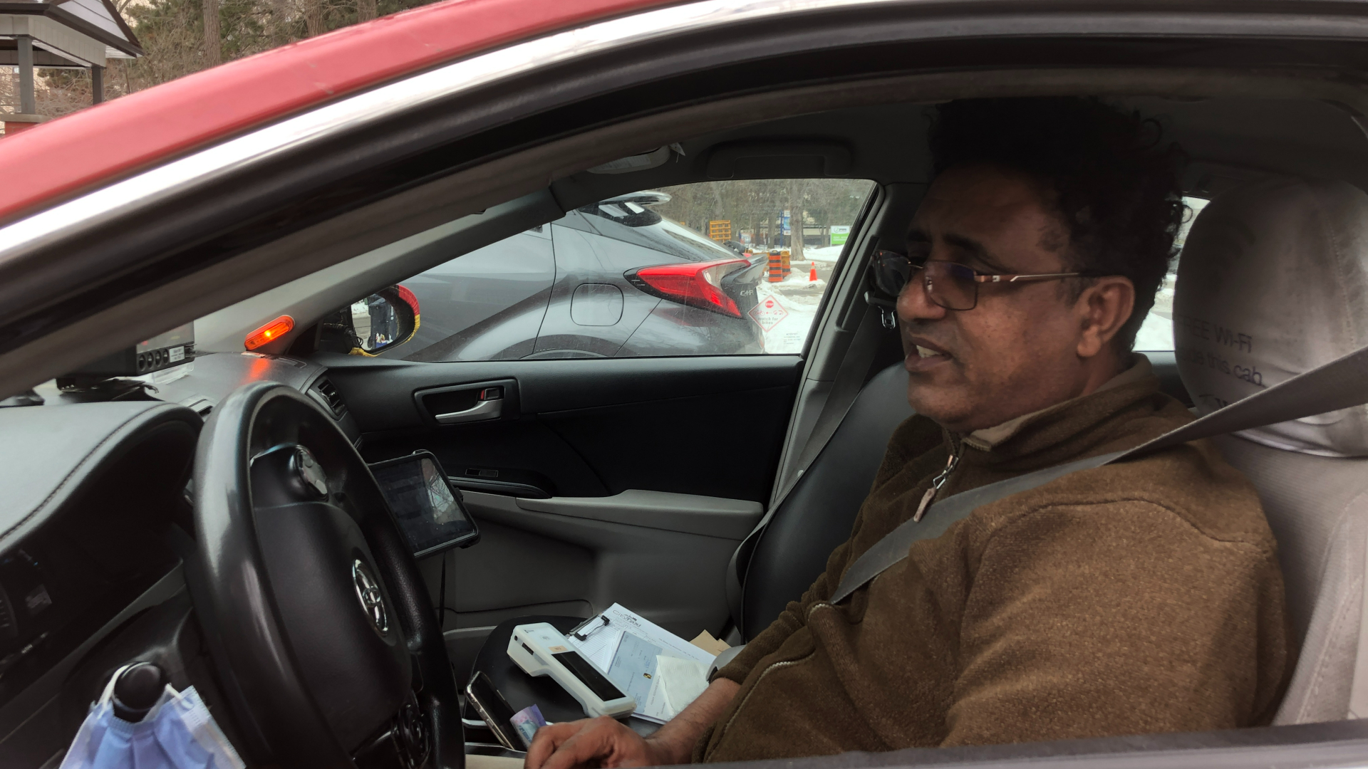 A man sitting in the front seat of a car