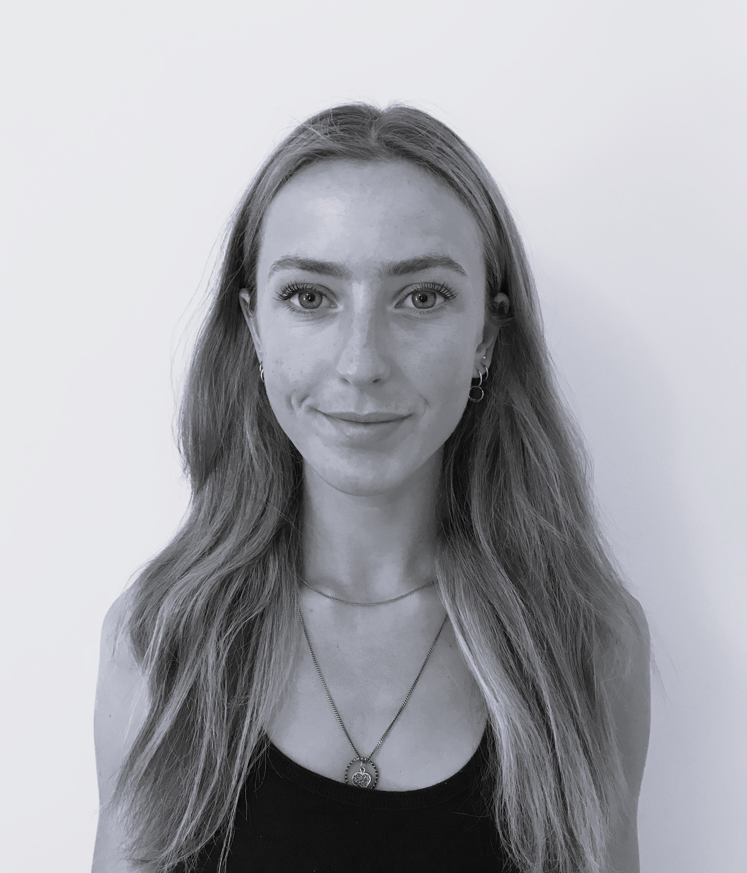 A black and white photo of a woman smiling