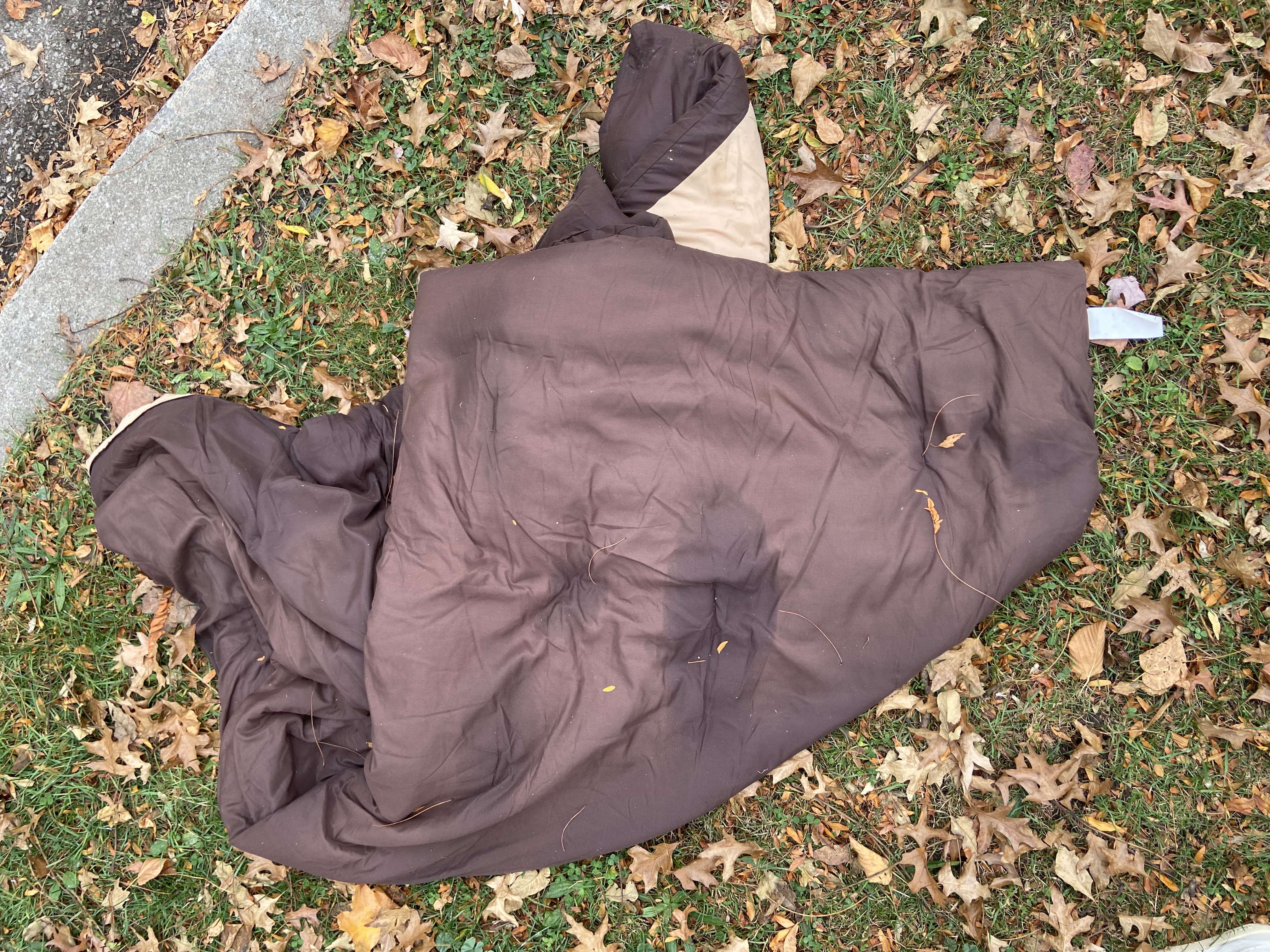 A brown duvet cover lying on grass